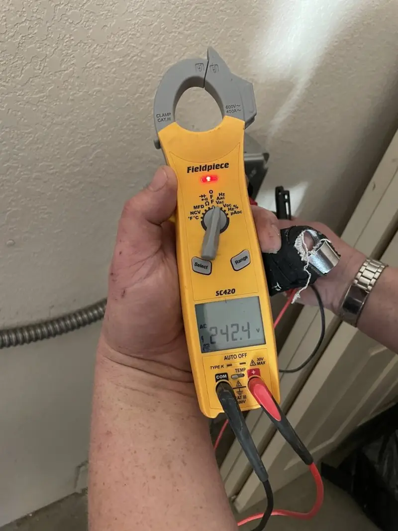 Voltage testing with clamp meter during Outlet Installation in Paradise